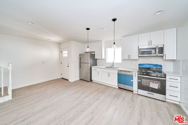 kitchen featuring white cabinetry, sink, a healthy amount of sunlight, and appliances with stainless steel finishes