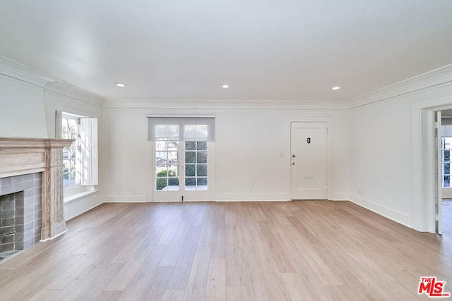 unfurnished living room featuring crown molding and light hardwood / wood-style flooring