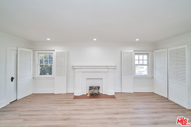 unfurnished living room with a fireplace, light hardwood / wood-style flooring, and ornamental molding