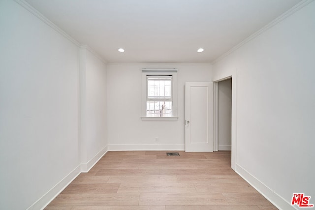 spare room with light hardwood / wood-style floors and ornamental molding