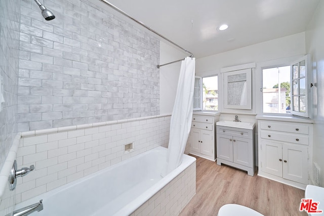 bathroom with shower / bath combination with curtain, vanity, and hardwood / wood-style flooring