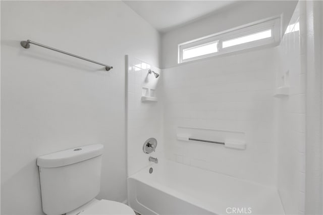 bathroom featuring tiled shower / bath and toilet