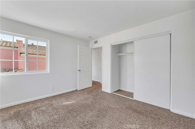 unfurnished bedroom with a closet and carpet