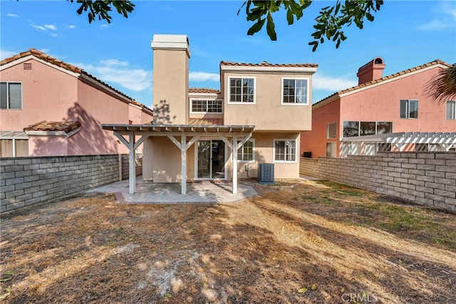 back of house featuring a pergola, cooling unit, and a patio area