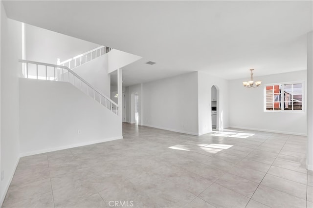 unfurnished living room with a notable chandelier