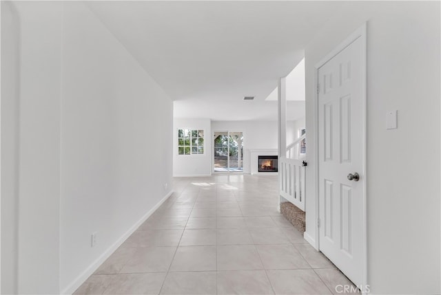 hall with light tile patterned floors