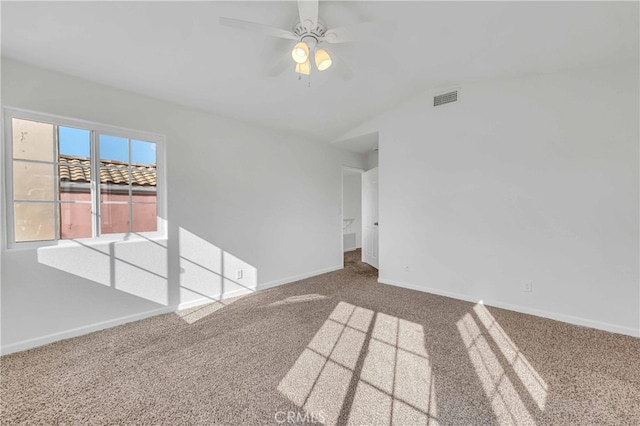 carpeted spare room with ceiling fan and lofted ceiling