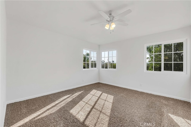 carpeted spare room with ceiling fan