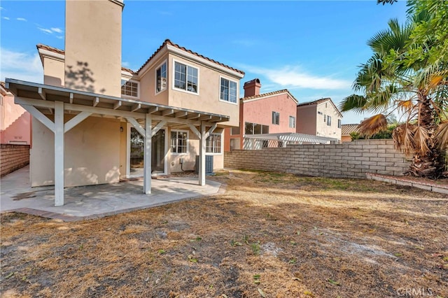 rear view of property featuring a patio and central AC