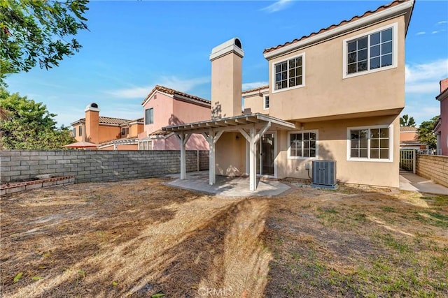 back of house with a pergola and central AC