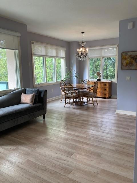 dining area featuring light hardwood / wood-style floors and a notable chandelier