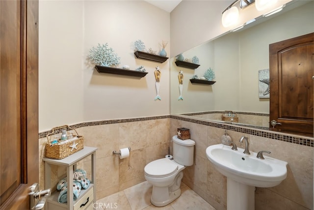 bathroom with tile walls, tile patterned flooring, and toilet