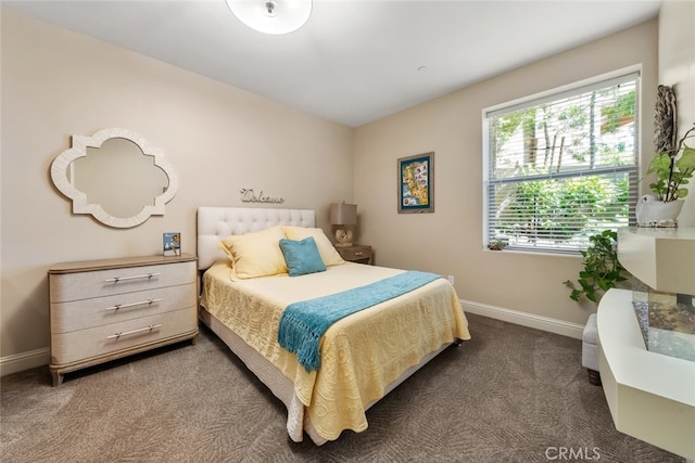 bedroom featuring dark colored carpet