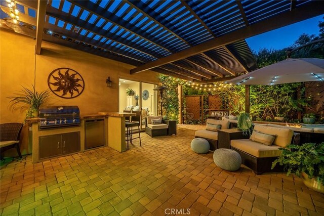 view of patio with a pergola, exterior kitchen, a grill, and outdoor lounge area