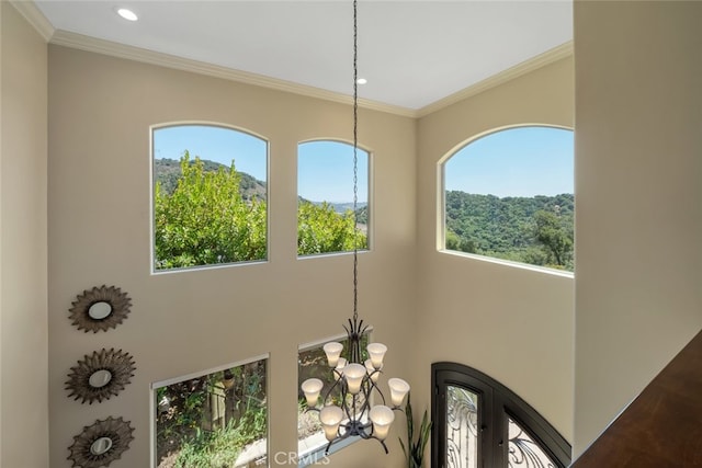 details with an inviting chandelier and ornamental molding