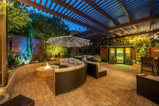 view of patio with a pergola and a fire pit