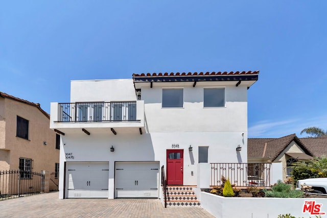 view of front of home featuring a balcony and a garage