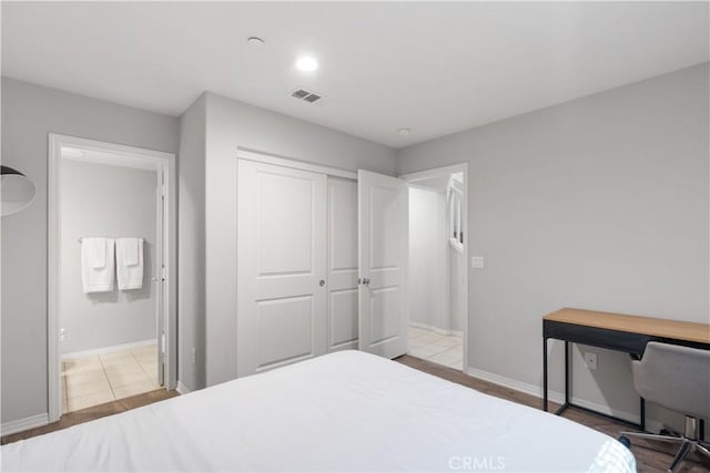 bedroom featuring a closet and light hardwood / wood-style flooring