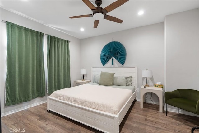 bedroom with hardwood / wood-style floors and ceiling fan