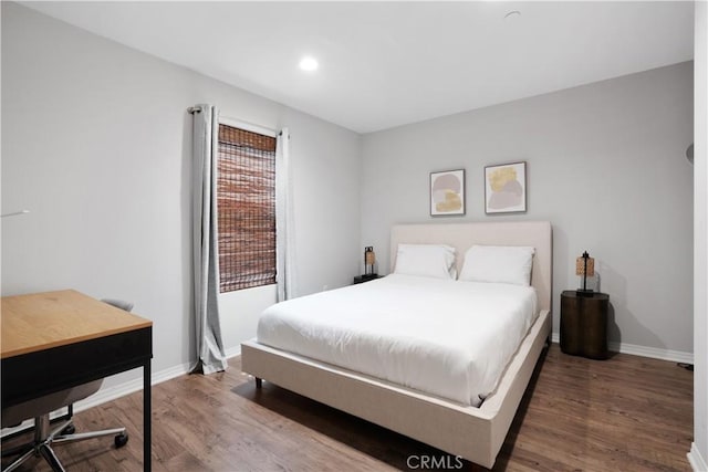 bedroom with hardwood / wood-style floors