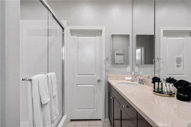 bathroom with vanity, tile patterned floors, and walk in shower