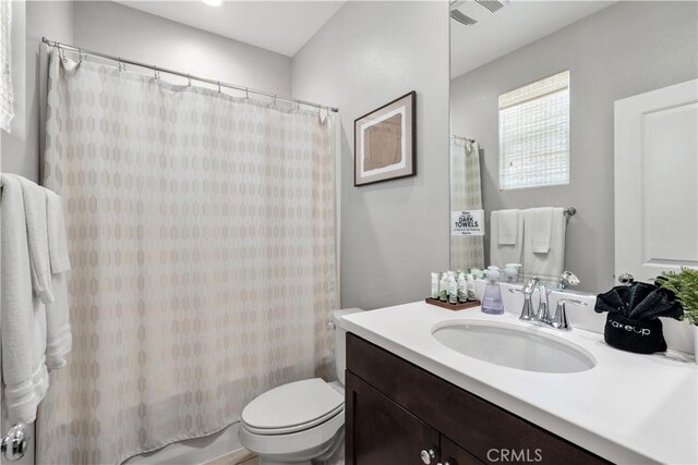 bathroom featuring toilet and vanity