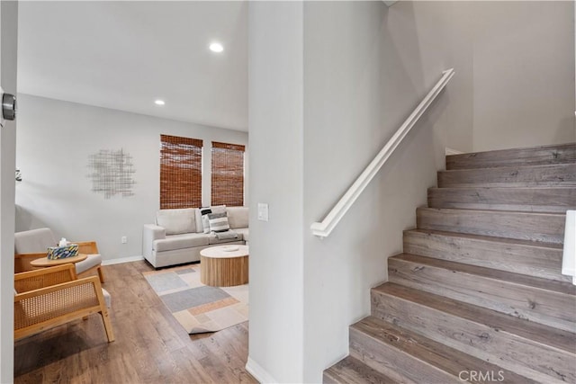 stairs featuring hardwood / wood-style flooring