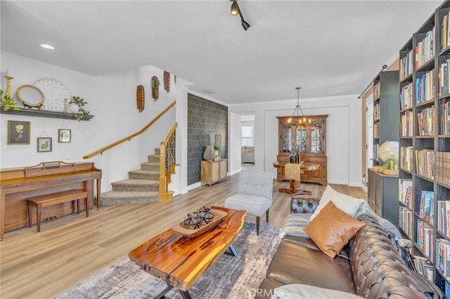 living room featuring light hardwood / wood-style floors and a chandelier