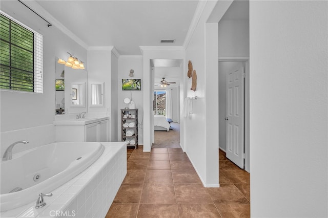 bathroom with tile patterned floors, crown molding, ceiling fan, tiled bath, and vanity