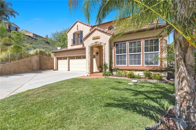 mediterranean / spanish house with a front yard and a garage