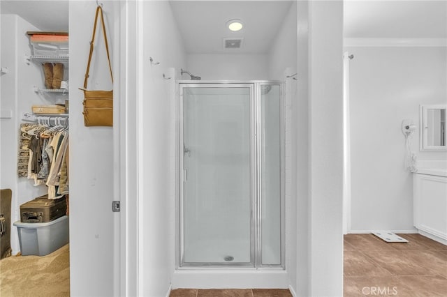 bathroom featuring tile patterned flooring and walk in shower