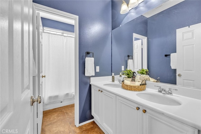 bathroom featuring tile patterned floors, walk in shower, vanity, and toilet