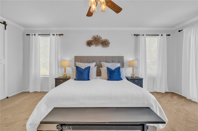 bedroom featuring ceiling fan, light colored carpet, a barn door, and ornamental molding