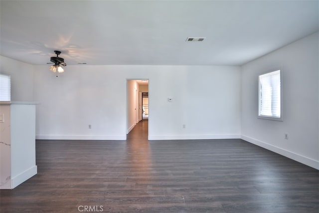 unfurnished room featuring ceiling fan and dark wood-type flooring