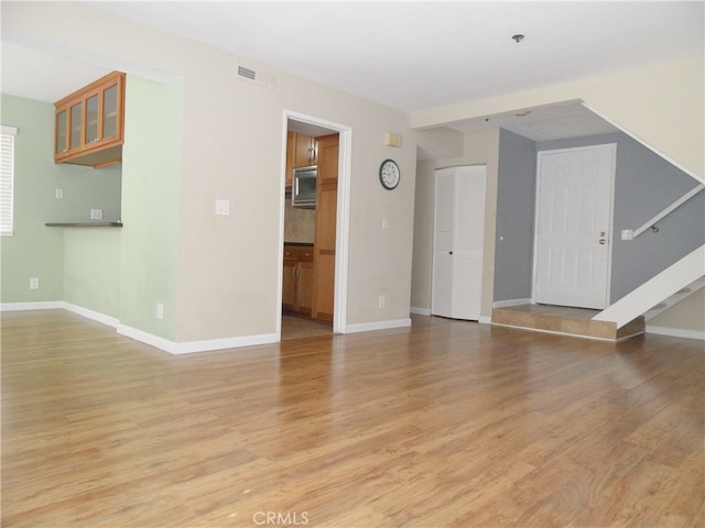 unfurnished living room featuring light wood-type flooring