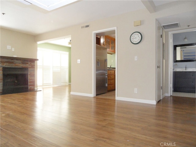 unfurnished living room with hardwood / wood-style floors