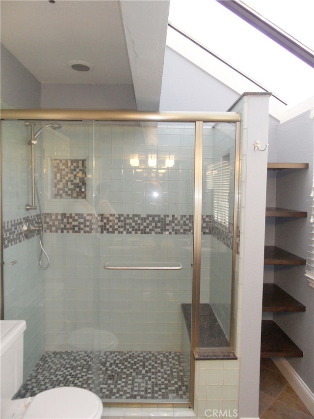 bathroom with lofted ceiling, a shower with shower door, toilet, and tile patterned flooring