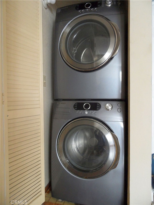 clothes washing area with stacked washer and clothes dryer