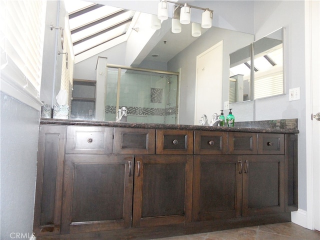 bathroom featuring tile patterned flooring, an enclosed shower, and vanity