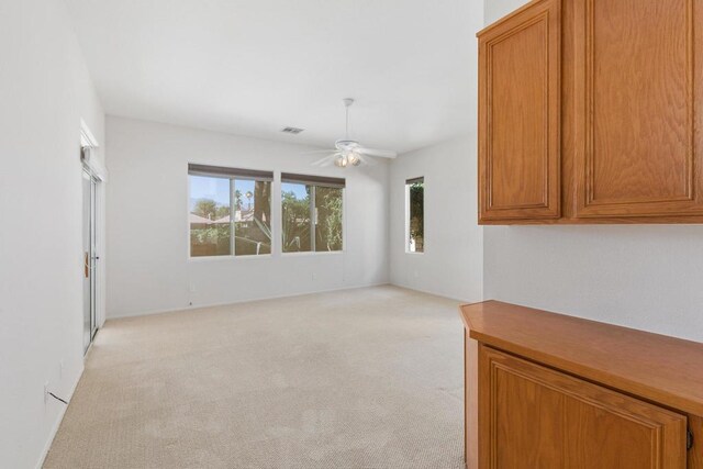 interior space with ceiling fan