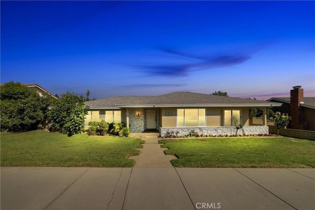 ranch-style house featuring a lawn