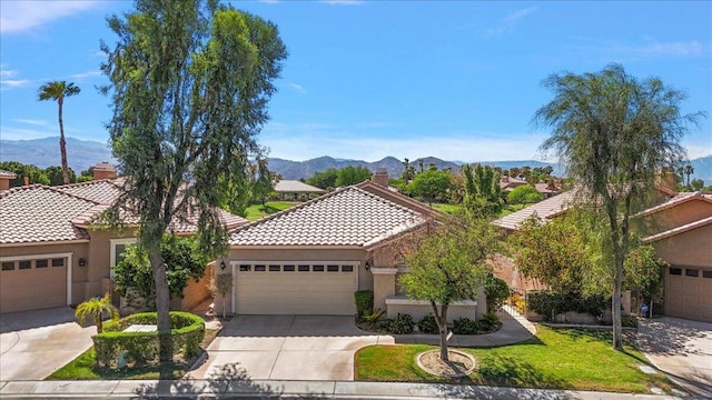 view of front of house featuring a mountain view and a garage