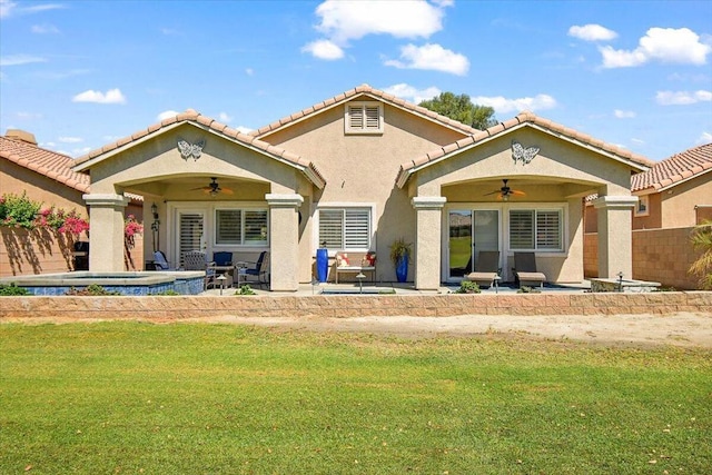 rear view of house with a patio area, ceiling fan, and a yard