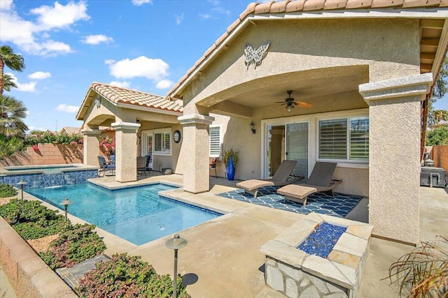 view of swimming pool with an in ground hot tub, a patio, and ceiling fan