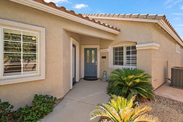 property entrance featuring a patio area and central AC unit