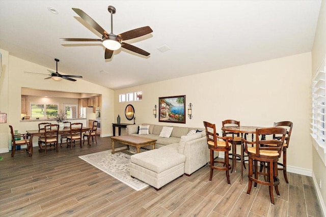 living room with hardwood / wood-style floors and lofted ceiling