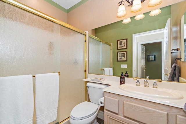 bathroom with vanity, toilet, walk in shower, and a chandelier