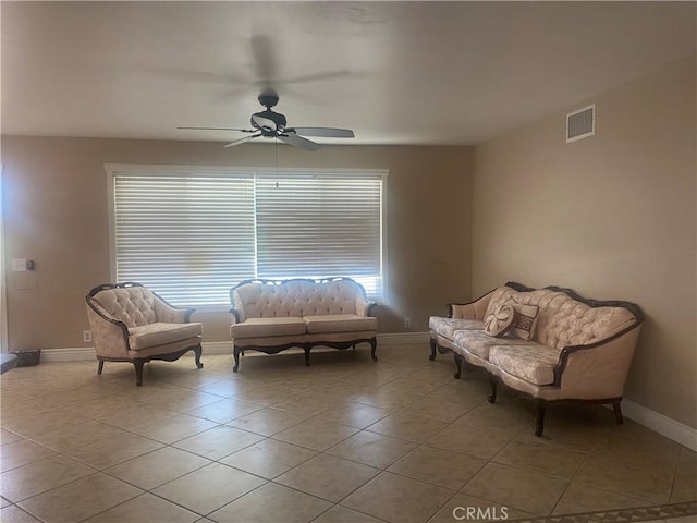 living area featuring ceiling fan and light tile patterned flooring