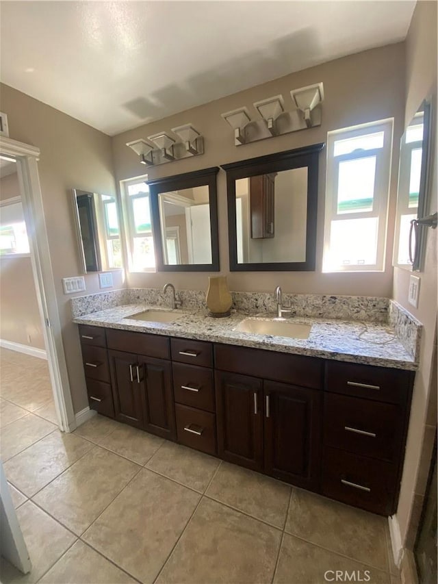 bathroom featuring tile patterned flooring, vanity, and a healthy amount of sunlight