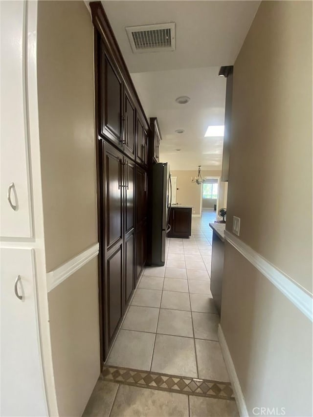 hall featuring light tile patterned floors